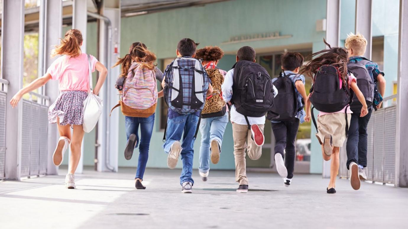 Children running into school