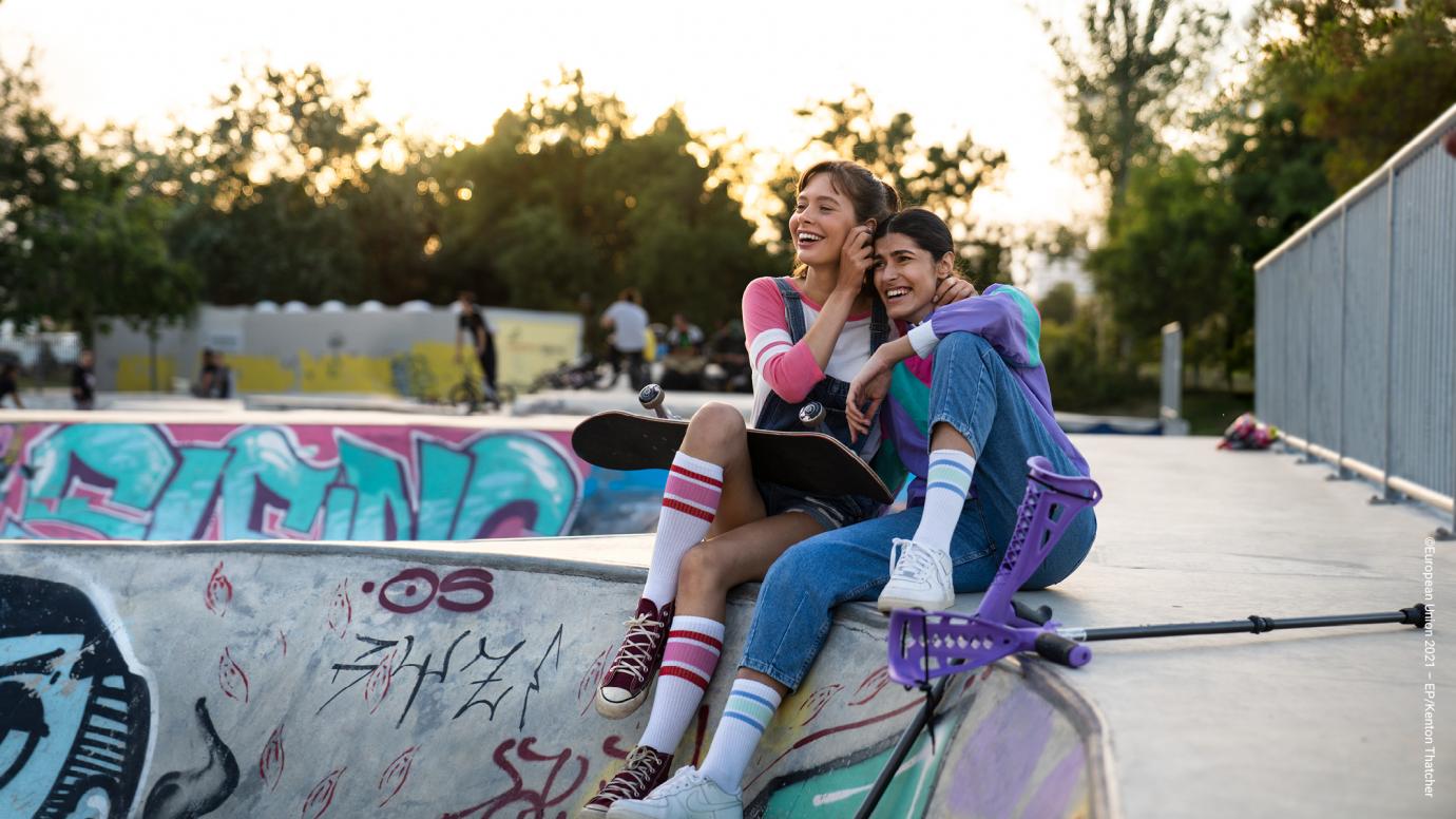 Two skater girls laughing