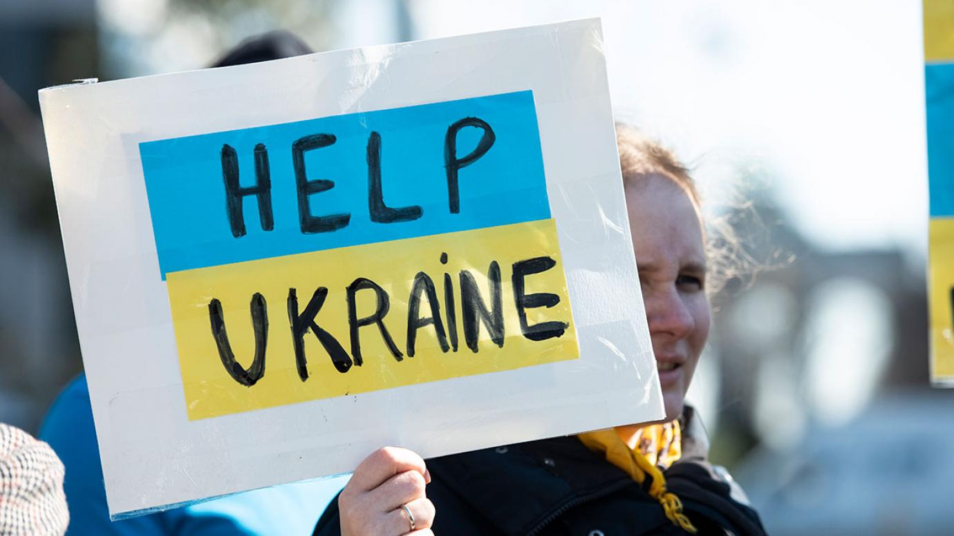 A demonstrator holding a sign with the inscription: "Help Ukraine"