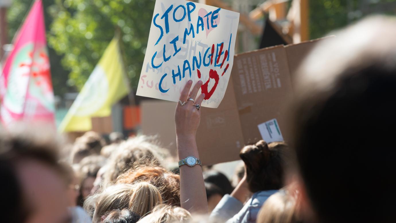 Sign with the inscription "Stop climate change" in a crowd of protesters at the Climate March in Brussels, 20 September 2019