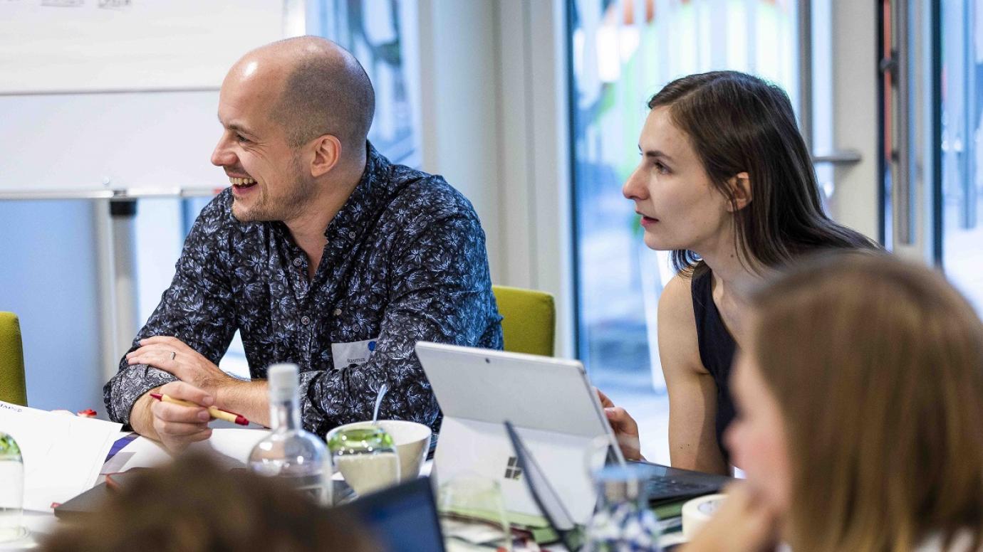 Members of the hub in discussion at a meeting