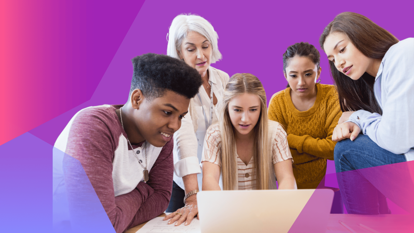 Group of young diverse people and older female mentor working in front of a laptop