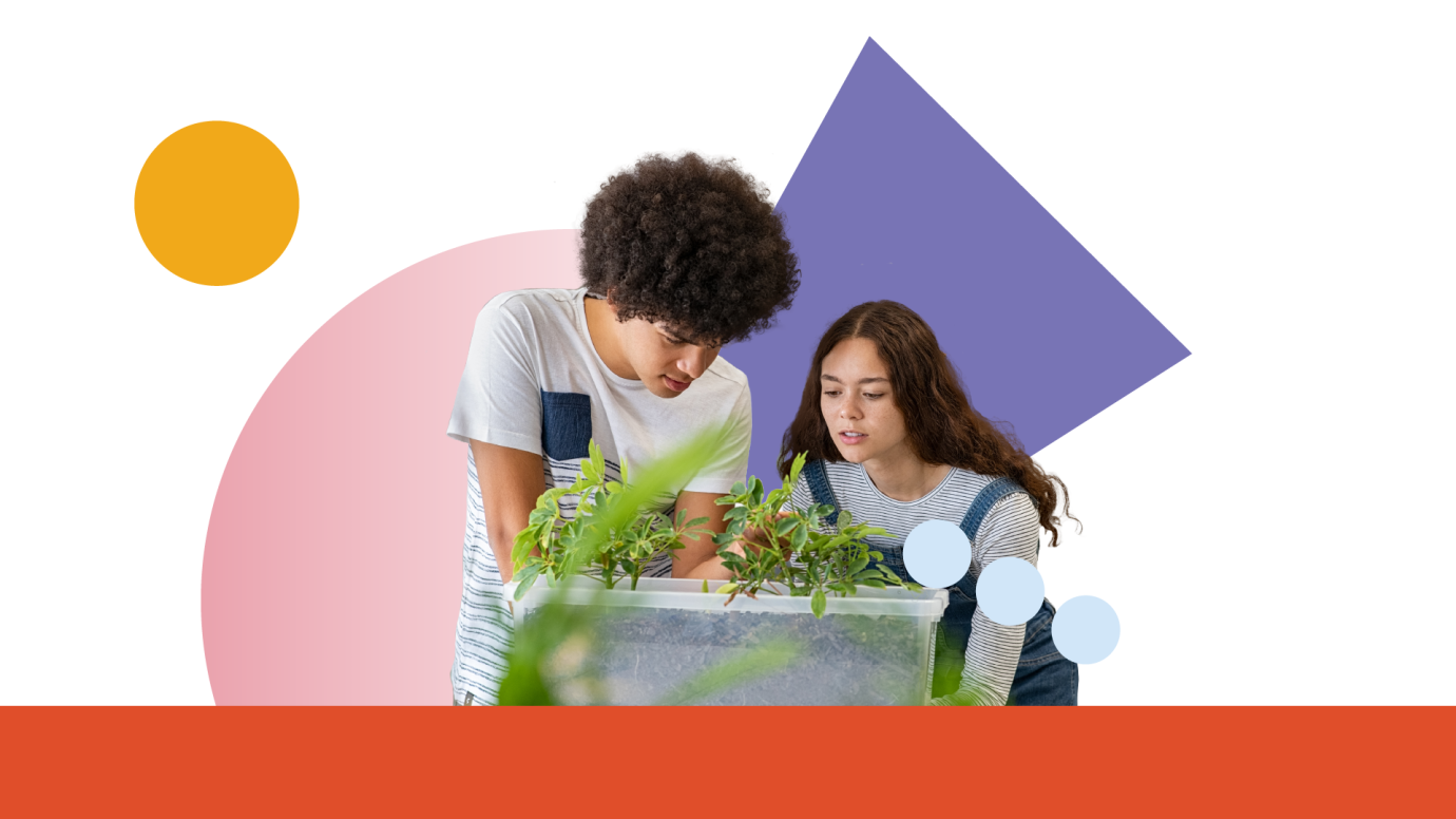 Two teenagers caring for a plant as part of a school assignment