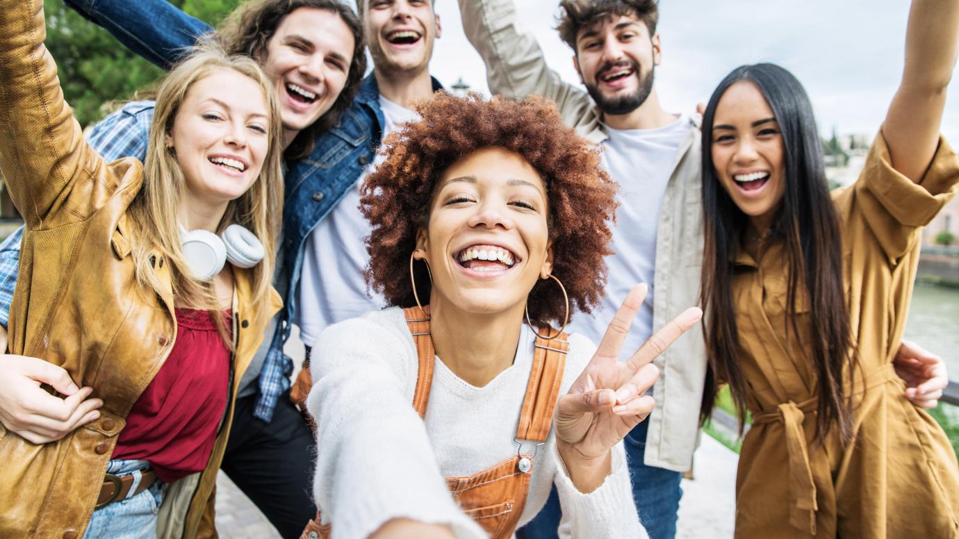 Group of young diverse friends taking a selfie in a scenic city