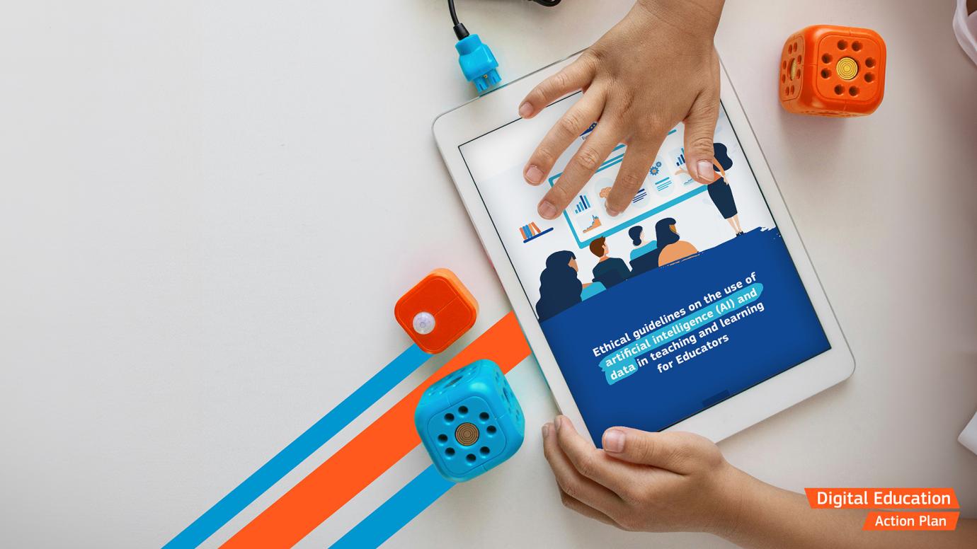 Hands holding a tablet and scrolling the Ethical Guidelines on the use of Artificial Intelligence (AI) and data in teaching and learning